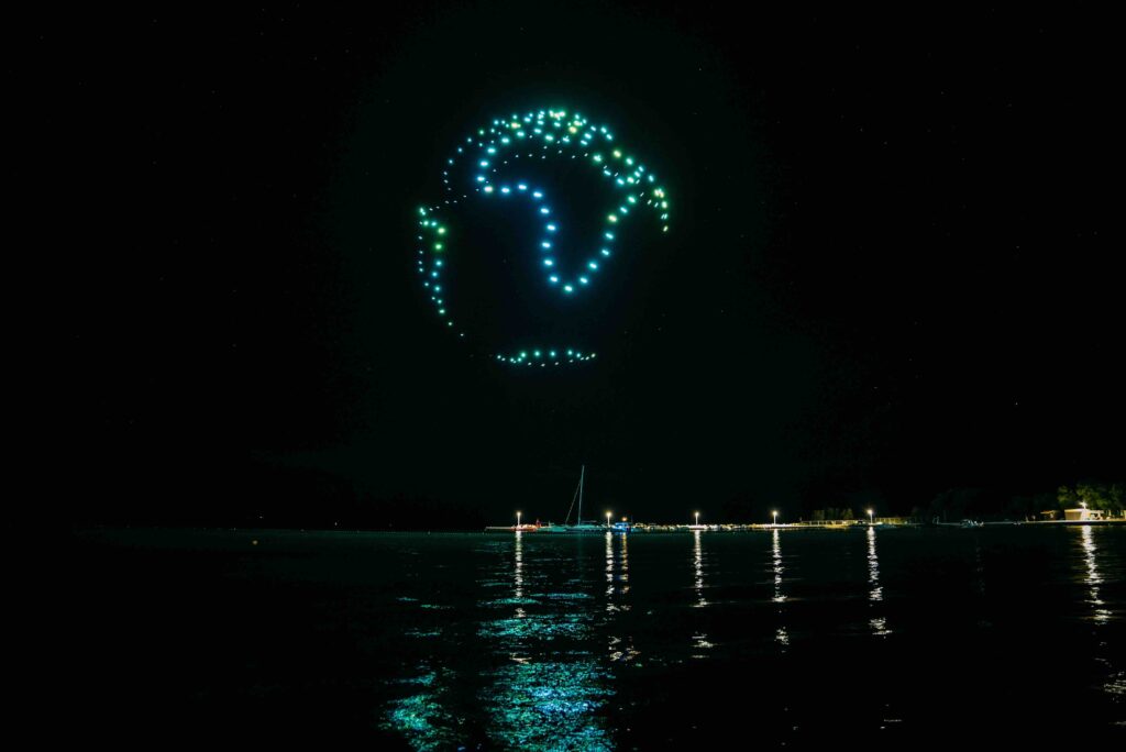 Skydance Drone Light Shows Earth globe drone formation above sea at night with glowing lights