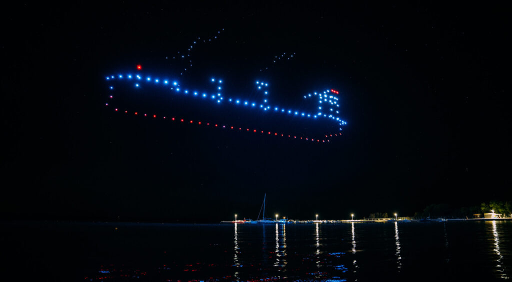 Skydance Drone Light Shows ship drone formation above sea at night with glowing lights