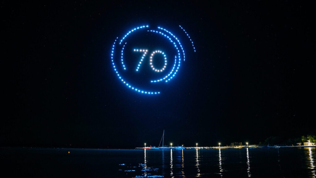 Skydance Drone Light Shows number 70 drone formation with circular light animation above sea at night